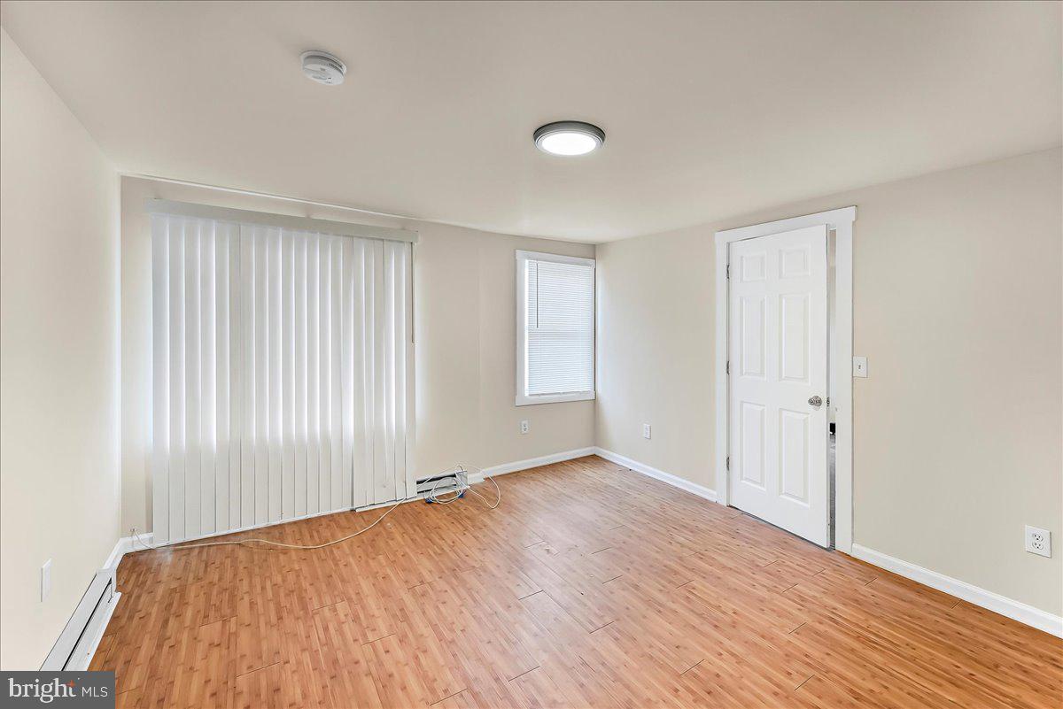 162 West Main Street Elkton, MD 21921 - Photo 6 of 41 an empty room with wooden floor and windows