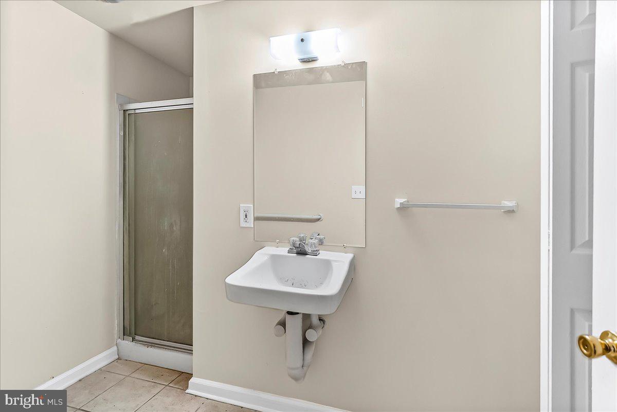 162 West Main Street Elkton, MD 21921 - Photo 7 of 41 a bathroom with a sink a mirror and a shower