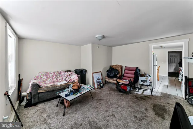 a living room with furniture a couch and a window