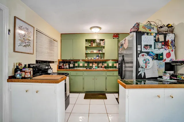 a kitchen with stainless steel appliances kitchen island granite countertop a stove and a sink