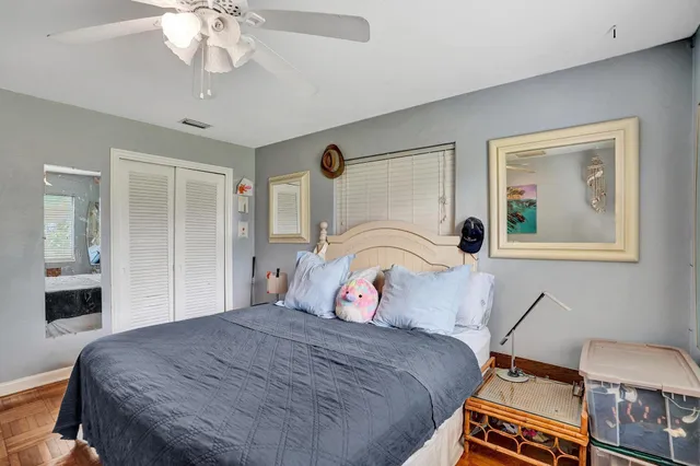 a bedroom with furniture and a wooden floor