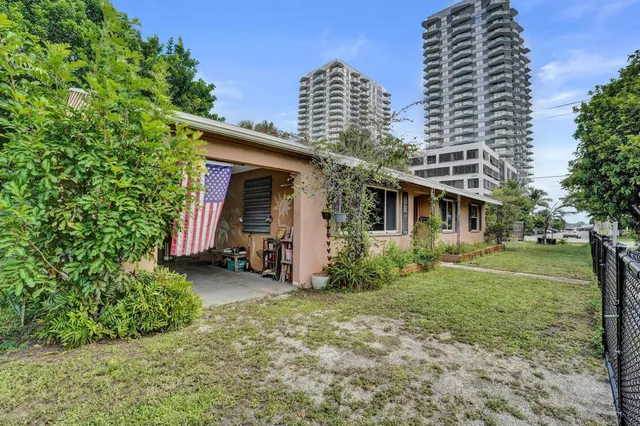 a view of a patio with table and chairs and potted plants