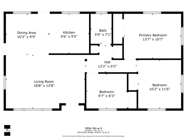 a view of a backyard with plants and large trees