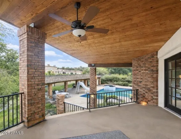 a view of a porch with a table and chairs