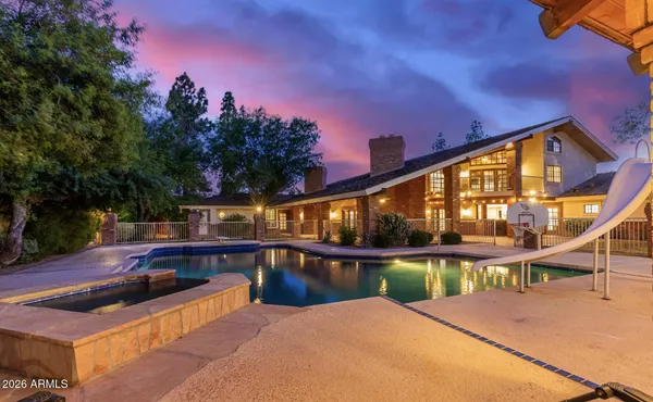 a view of a house with swimming pool and sitting area