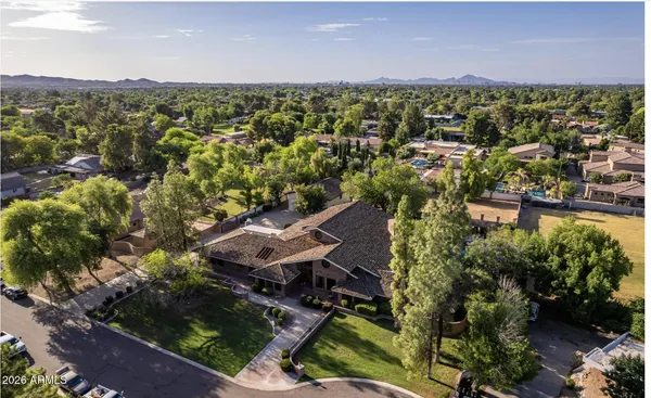 an aerial view of a houses with a yard