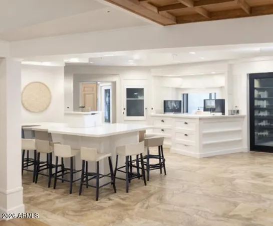 a large kitchen with a table and chairs
