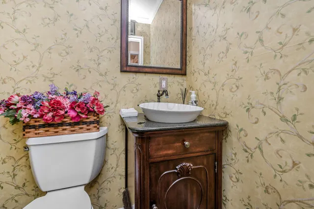 a bathroom with a sink toilet and a mirror