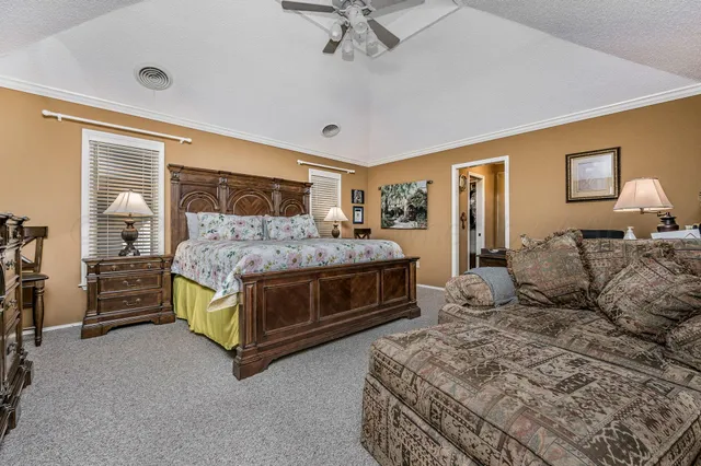 a bedroom with a bed and ceiling fan