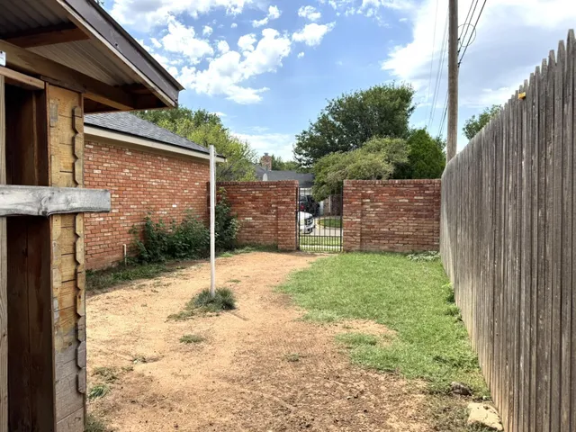 a backyard of a house with a table and chairs