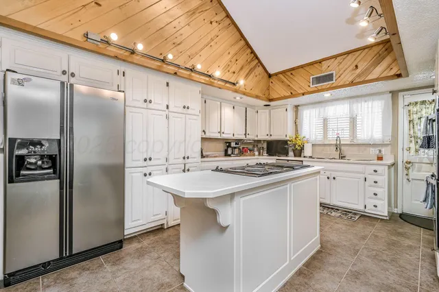 a kitchen with white cabinets and white stainless steel appliances