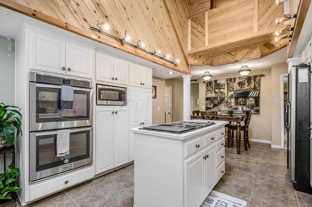 a kitchen with stainless steel appliances granite countertop a stove and a refrigerator