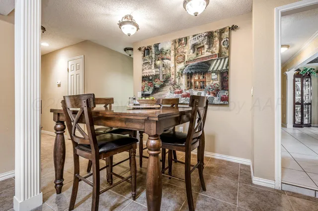 a view of a dining room with furniture and window
