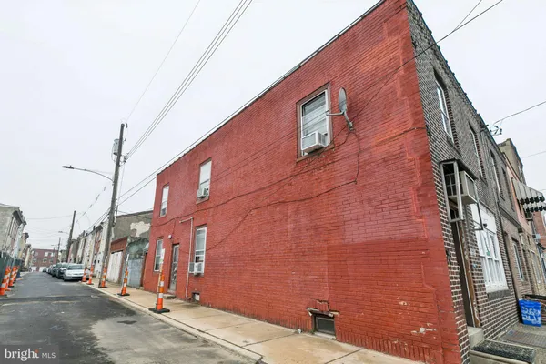 a brick building with a street sign on the side of it