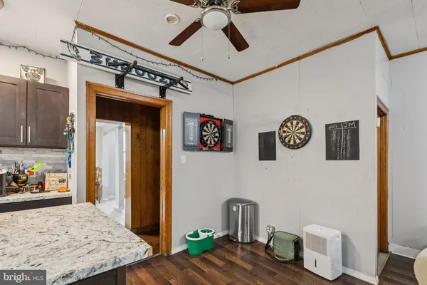 a kitchen with stainless steel appliances granite countertop a stove top oven a sink dishwasher and a refrigerator with wooden cabinets