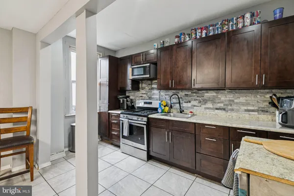 a kitchen with a refrigerator and cabinets