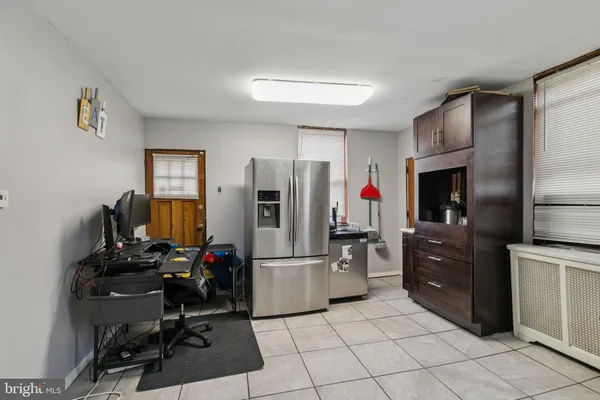 a kitchen with a refrigerator and cabinets