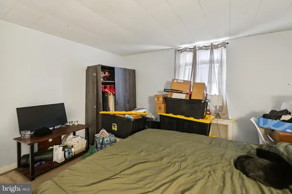 a bedroom with bed and wooden floor