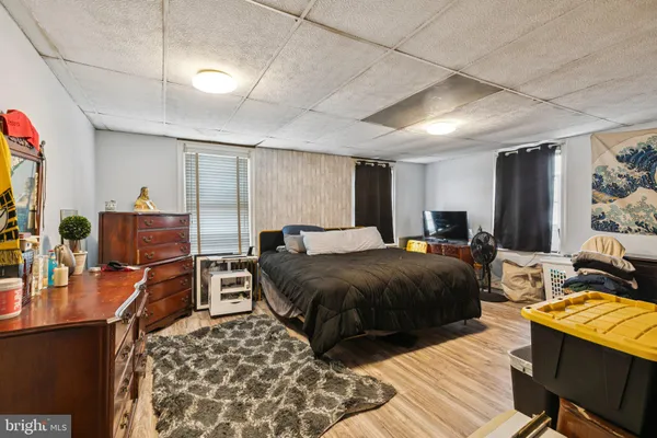 a bedroom with two beds and a dresser