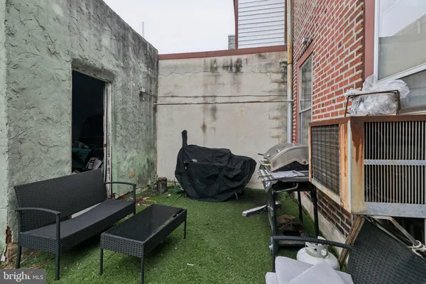 a backyard of a house with outdoor seating