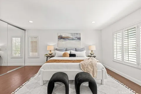 a bedroom with a bed and a large window