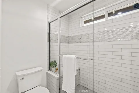 a bathroom with a toilet and shower