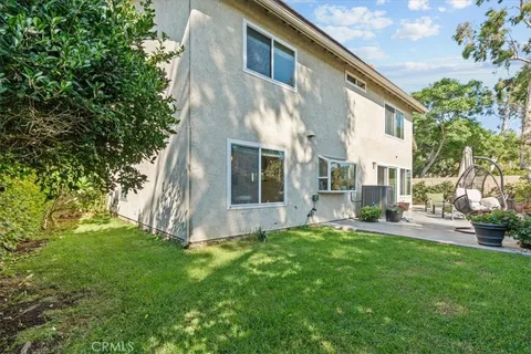 a view of backyard of house with green space