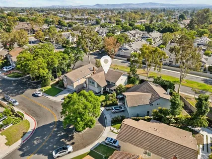 an aerial view of residential houses with outdoor space