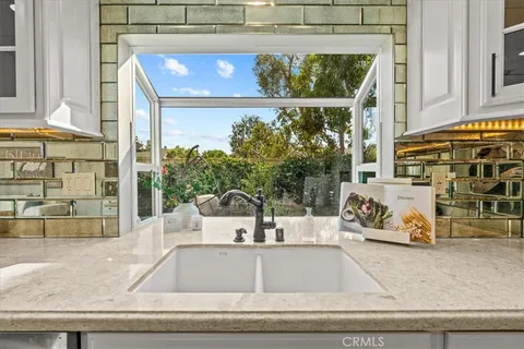 a view of a living room with a floor to ceiling window and potted plant