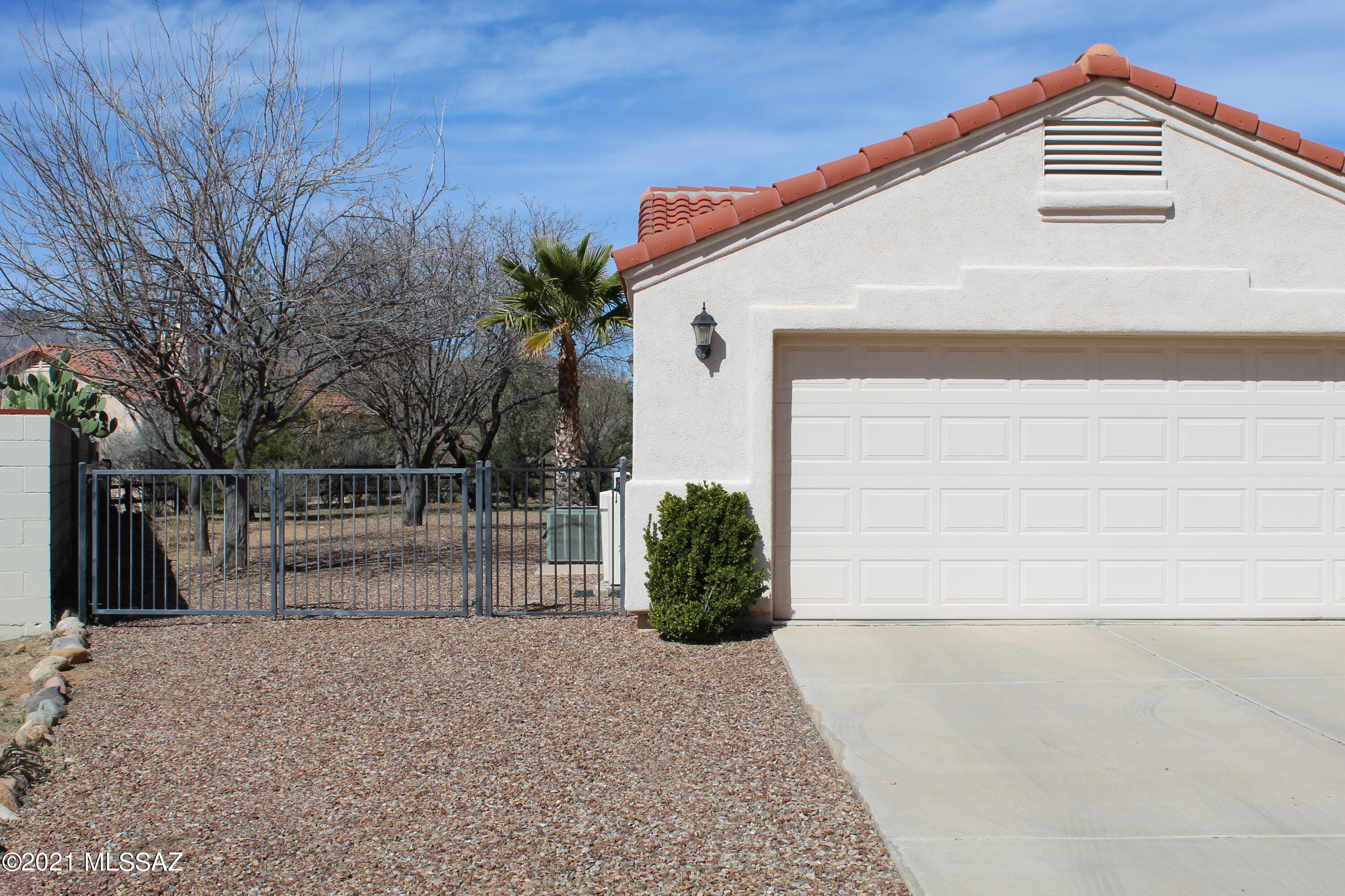 1704 Leary Court Rio Rico, AZ 85648 - Photo 2 of 37 a view of backyard with small cabin and wooden fence