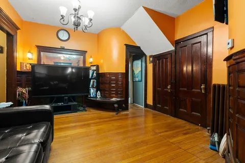 a view of a livingroom with furniture wall and chandelier