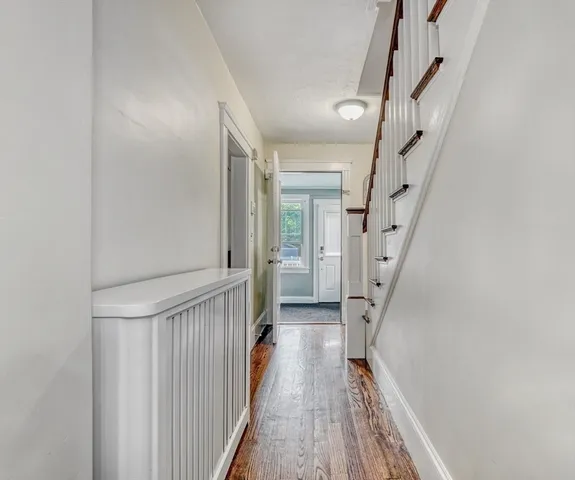 a view of a backyard with a small yard and a large tree
