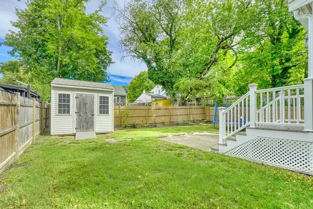 a view of a house with a yard and a garden