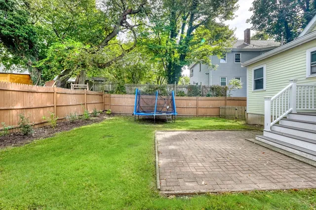 a view of a backyard with wooden fence