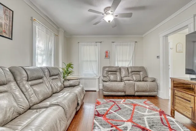 a living room with furniture and a chandelier