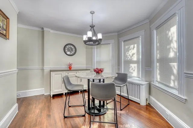 a view of a dining room with furniture window and wooden floor