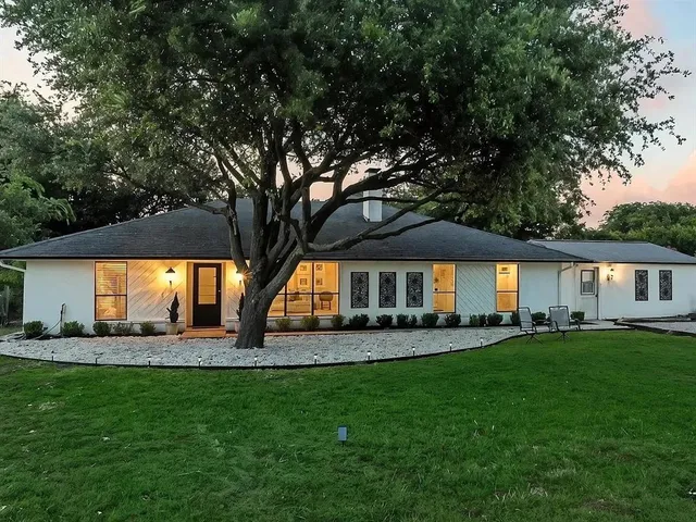 a view of a house with a yard and sitting area