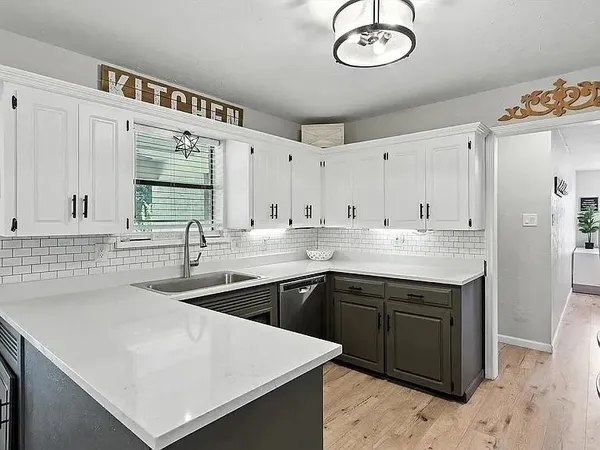 a kitchen with stainless steel appliances granite countertop a sink a stove and a refrigerator