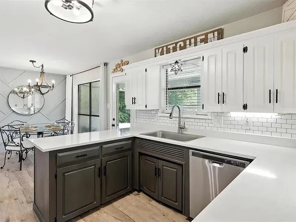 a kitchen with a sink stove and cabinets