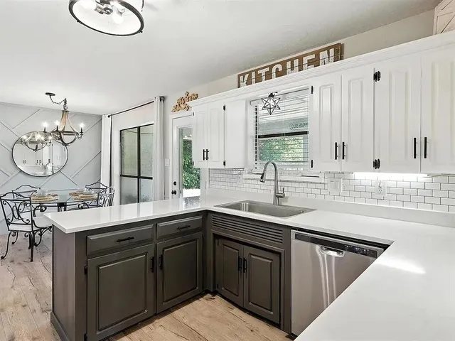 a kitchen with a sink stove and cabinets
