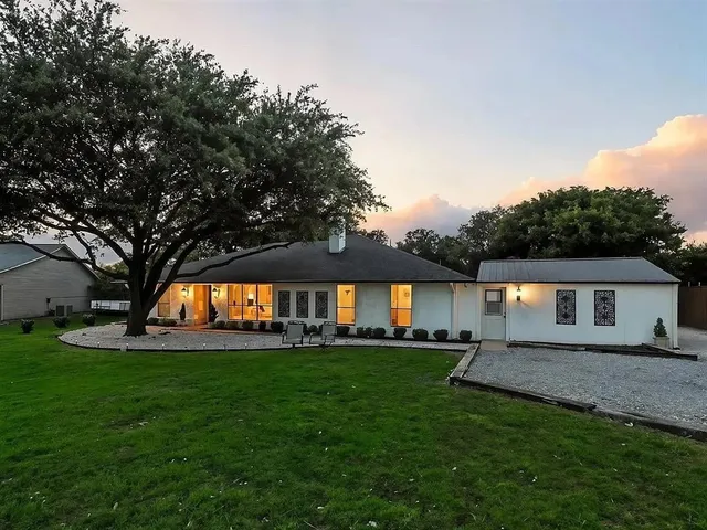 a house view with swimming pool and garden