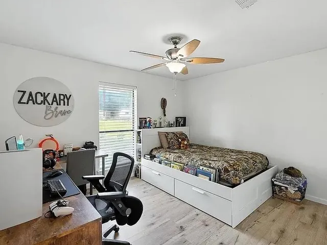 a bedroom with a workspace