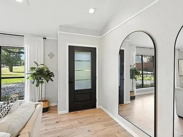 a view of room with wooden floor and a potted plant