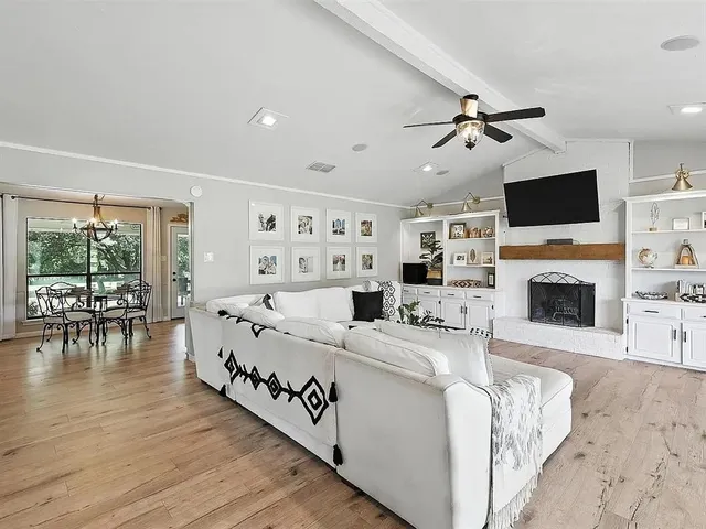 a living room with furniture fireplace and flat screen tv