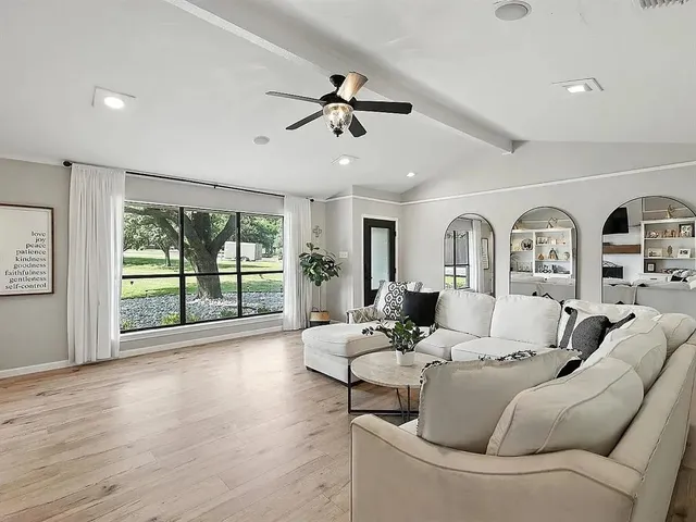 a living room with furniture and a large window