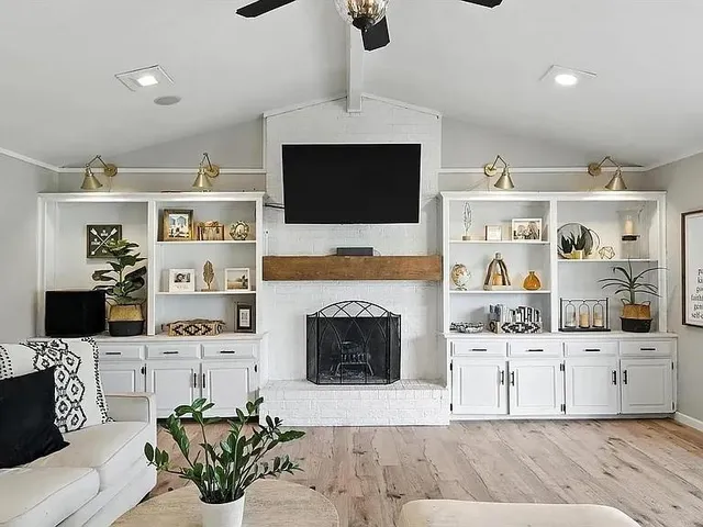 a living room with furniture a fireplace and a flat screen tv