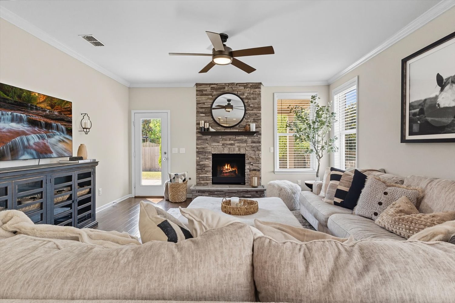 4706 Venito Street Mount Juliet, TN 37122 - Photo 11 of 39 a living room with furniture a fireplace and a flat screen tv