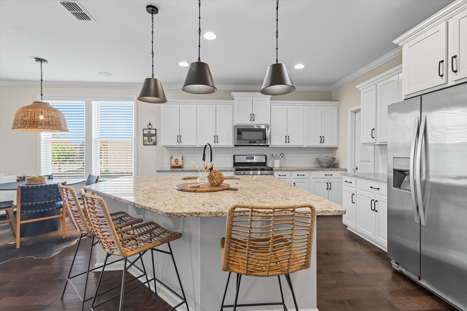 4706 Venito Street Mount Juliet, TN 37122 - Photo 6 of 39 a kitchen with stainless steel appliances granite countertop a sink a stove a refrigerator and chairs
