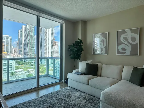 a living room with furniture and a large window