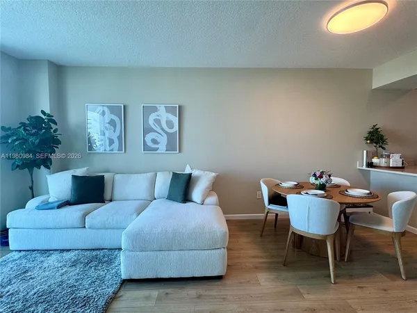 a living room with furniture and a chair